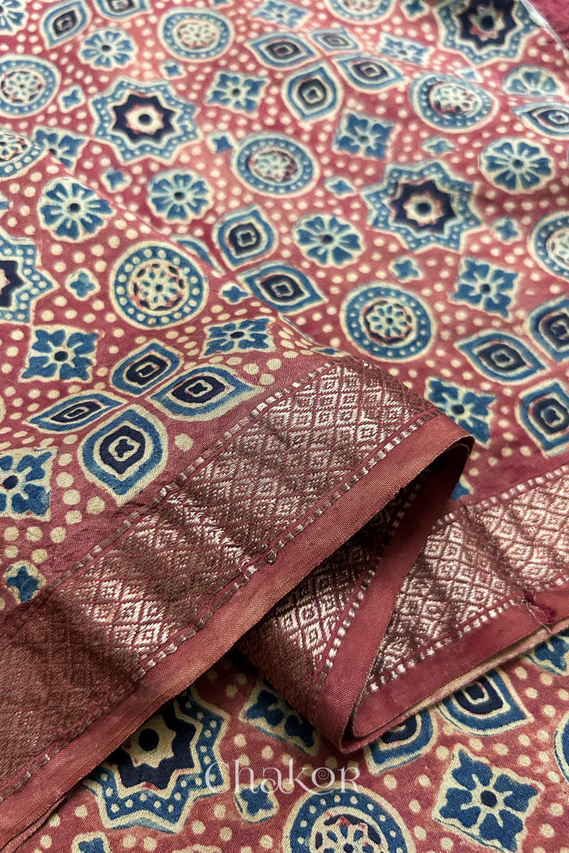 Woven Zari border on natural red Ajrakh silk fabric for designer sleeves.