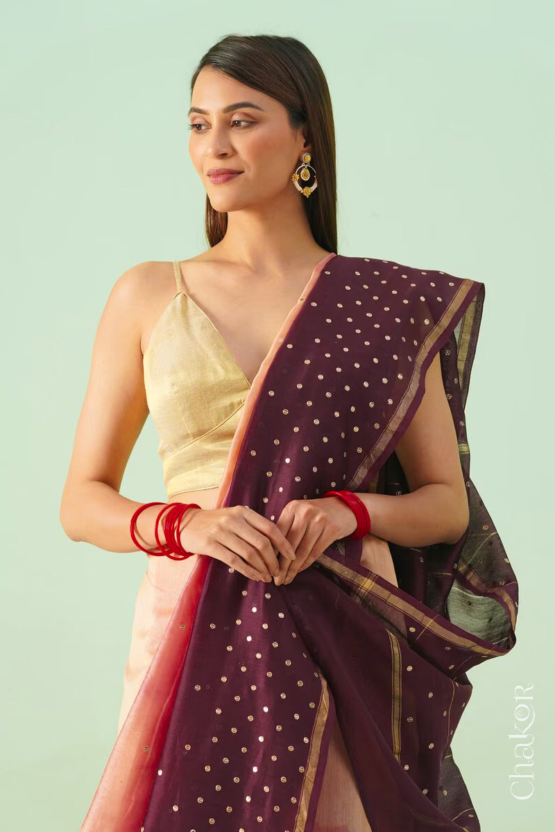 Front close view of peach maroon shaded Chanderi silk cotton saree showing woven body and embroidered details.
