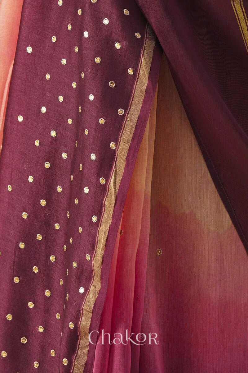 Close-up of hand-embroidered sequin and zari work on peach maroon Chanderi silk cotton saree.
