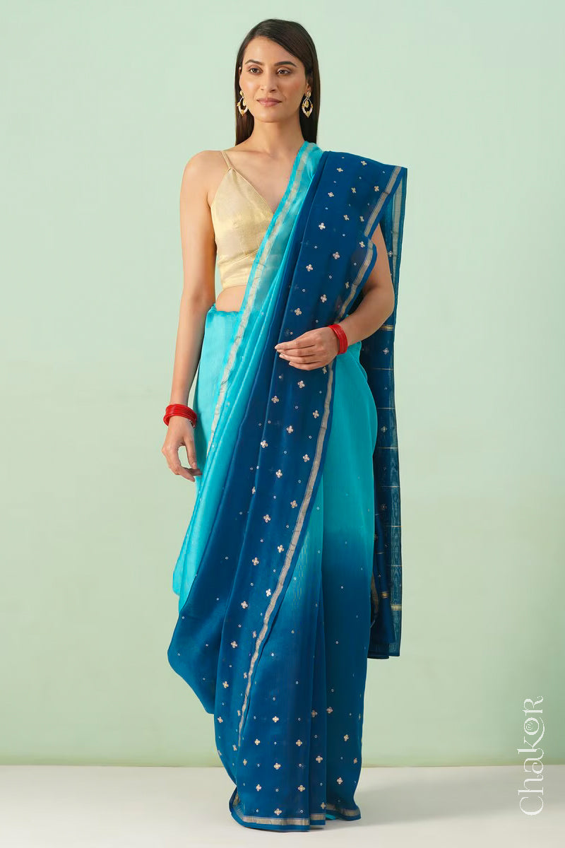 Full-length view of turquoise navy shaded Chanderi silk cotton saree with ombre effect and tissue-striped pallu.
