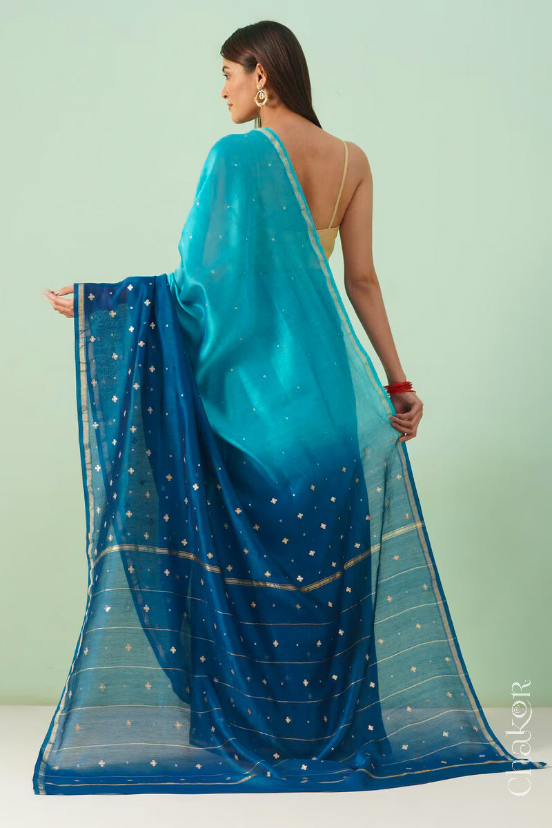 Back view of turquoise navy shaded Chanderi silk cotton saree displaying ombre dyeing and tissue pallu.
