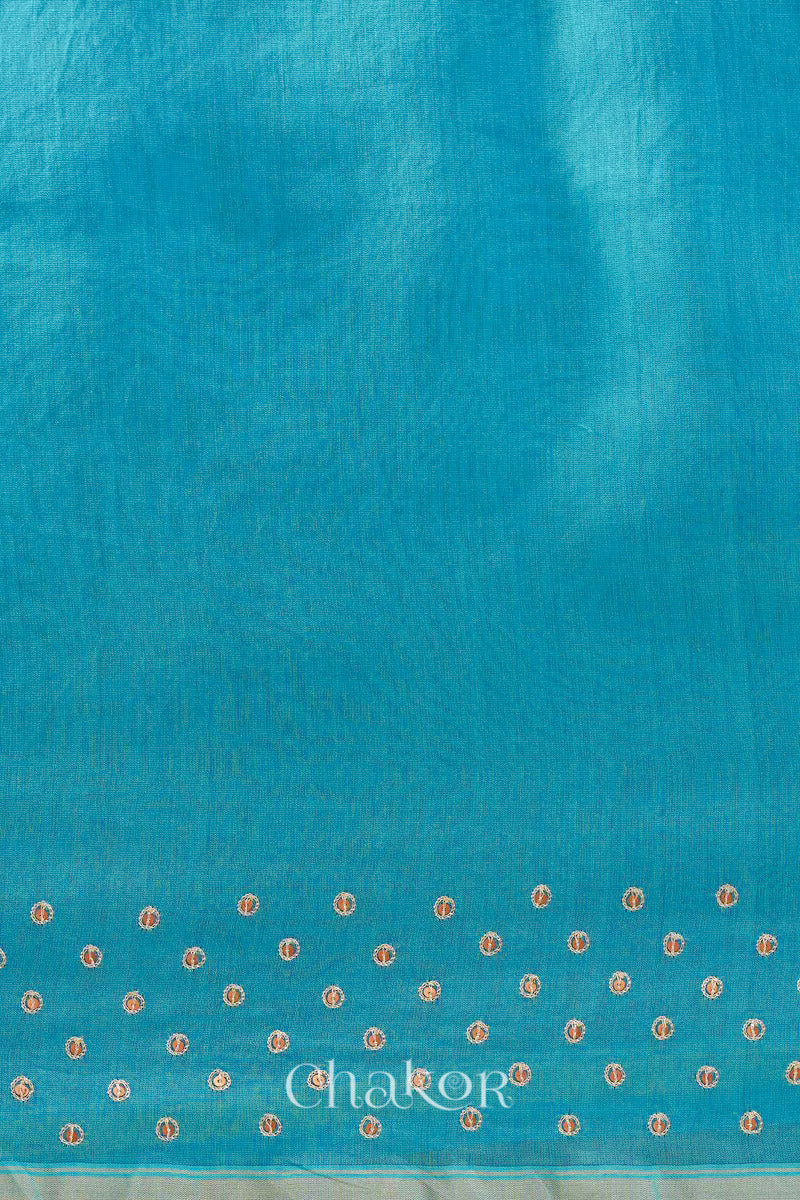 Detail of unstitched blouse piece and scattered sequin embroidery on turquoise navy Chanderi silk cotton saree.
