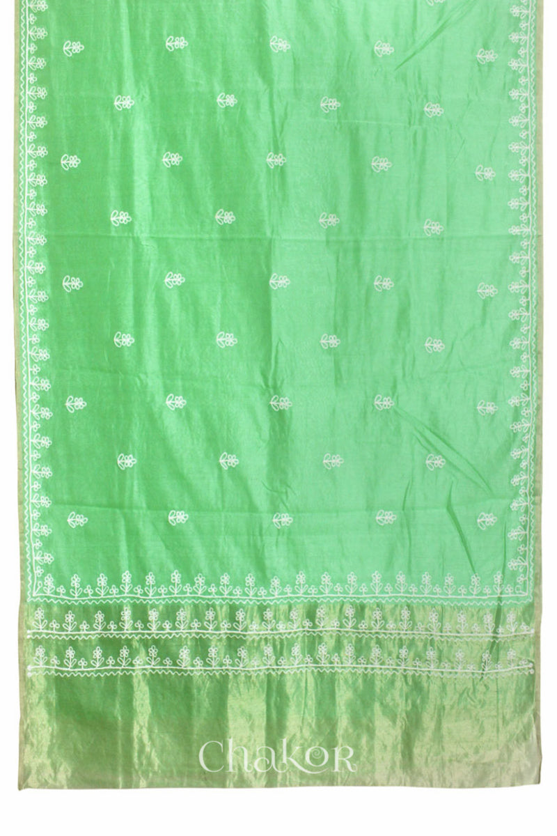 Flat view of sea green Chanderi silk cotton saree showing tissue pallu and aari embroidery.
