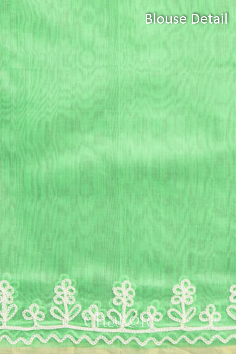 Blouse fabric detail in sea green Chanderi silk cotton with woven texture.
