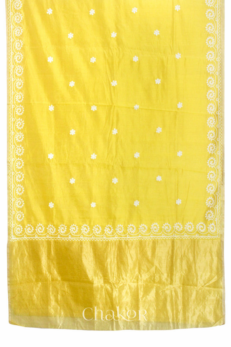 Flat view of yellow Chanderi silk cotton saree showing tissue pallu and aari embroidery.
