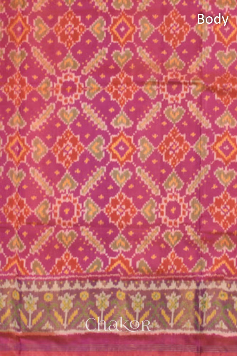Close up of Handloom Pink Rajkoti Patola Ikat Mulberry Silk Saree with tissue borders, and mauve pallu woven using traditional designs in Gujarat.