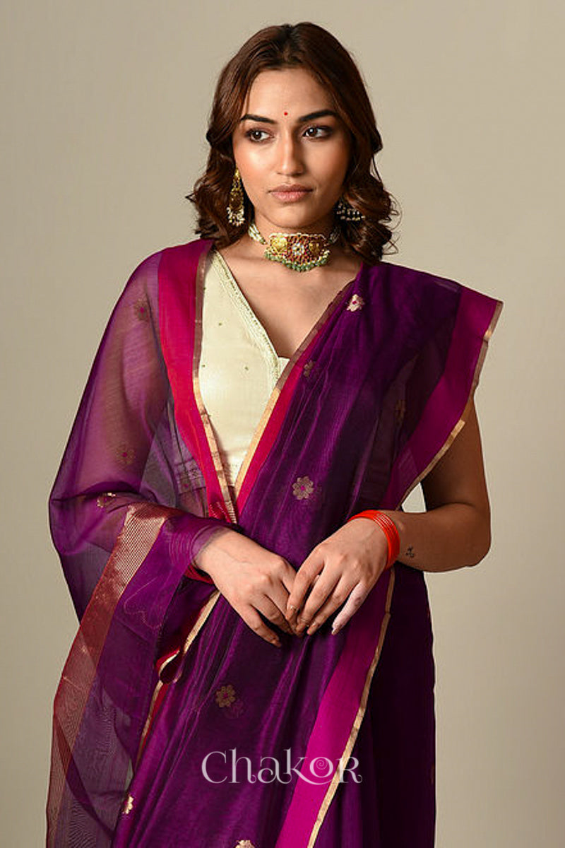 Model wearing Magenta Chanderi silk cotton saree draped to show Ganga Jamuna borders and woven phool butti motifs.
