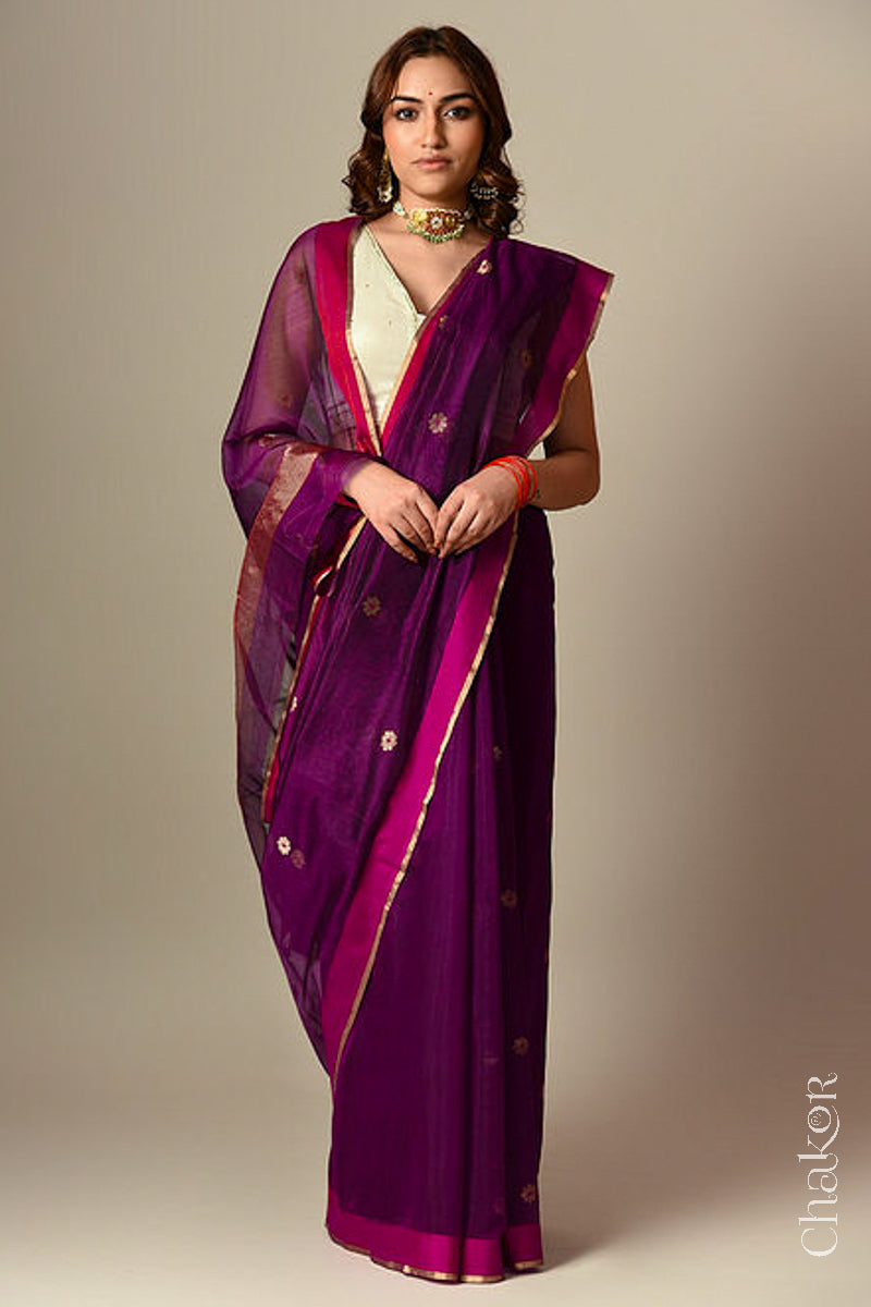 Model wearing a Magenta Chanderi silk cotton saree with Ganga Jamuna borders and tissue-striped pallu.
