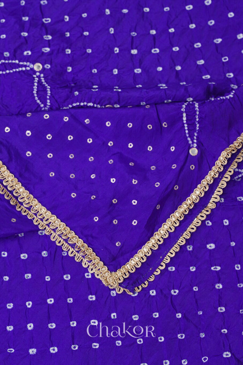 Close-up of a purple Bandhani mulberry silk dupatta with tie-dye dot pattern & detailed with mirror work & golden lace on edge