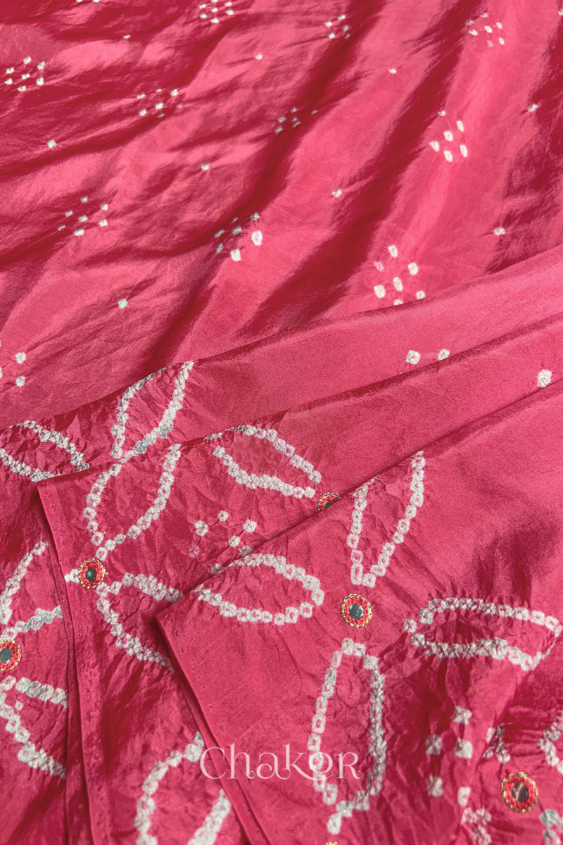 Close up of Strawberry Pink Bandhani Mulberry Silk Saree with mirror embroidery.