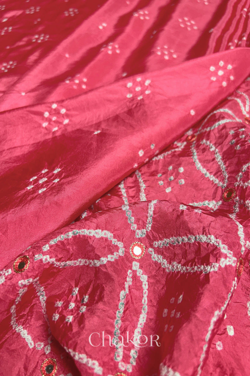 Close up of Strawberry Pink Bandhani Mulberry Silk Saree with mirror embroidery.