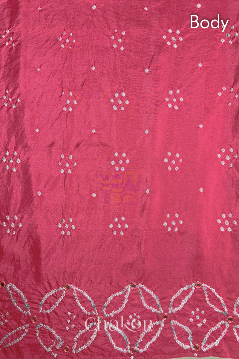 Body pattern of a pink saree in silk fabric with intricate white bandhani patterns and 'Chakor' branding.