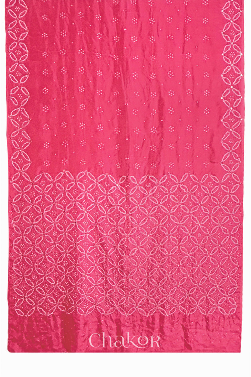 Close up of Strawberry Pink Bandhani Mulberry Silk Saree with mirror embroidery.
