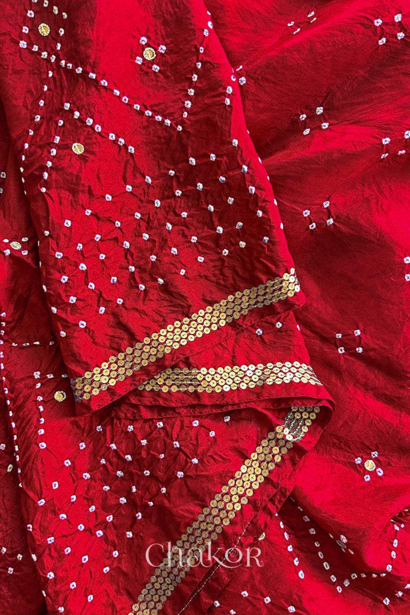 Close up of Red Bandhani Mulberry Silk Saree, rai bandhej with sequins embroidery.