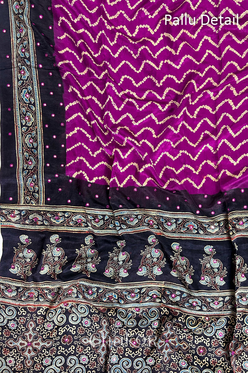 Close up of Magenta Bandhani Saree with Black Ajrakh printed border and pallu in pure gaji silk with traditional bandhej tie-dye & mirror work, handcrafted in Kutch. 