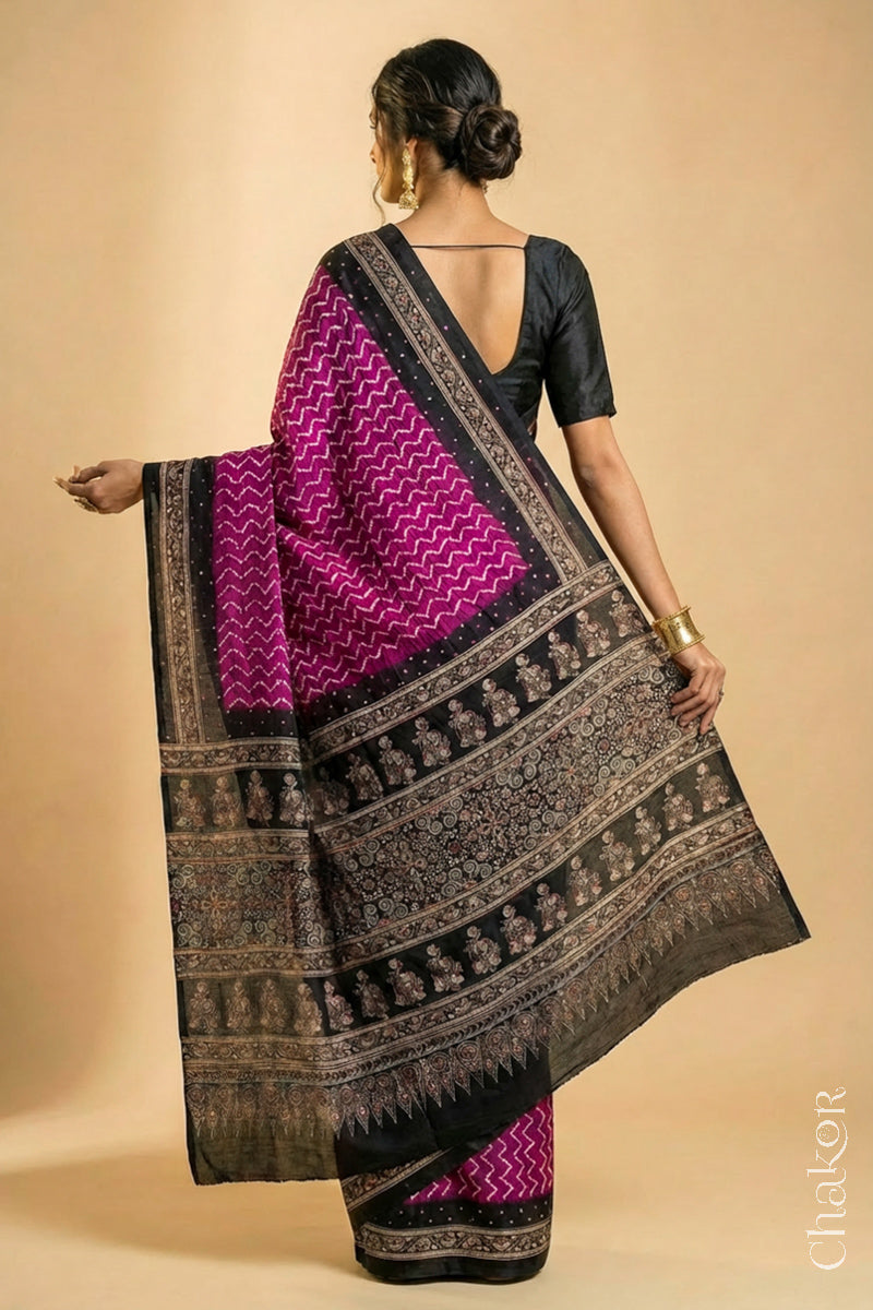 Woman wearing Magenta Bandhani Saree with Black Ajrakh printed border and pallu in pure gaji silk with traditional bandhej tie-dye & mirror work, handcrafted in Kutch. 