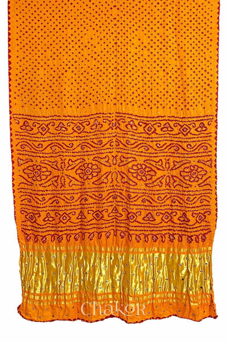 Full view of traditional Yellow Bandhani Gaji Silk Handcrafted Saree, with rai bandhej patterns in red dots and mirror and sequins embroidery.