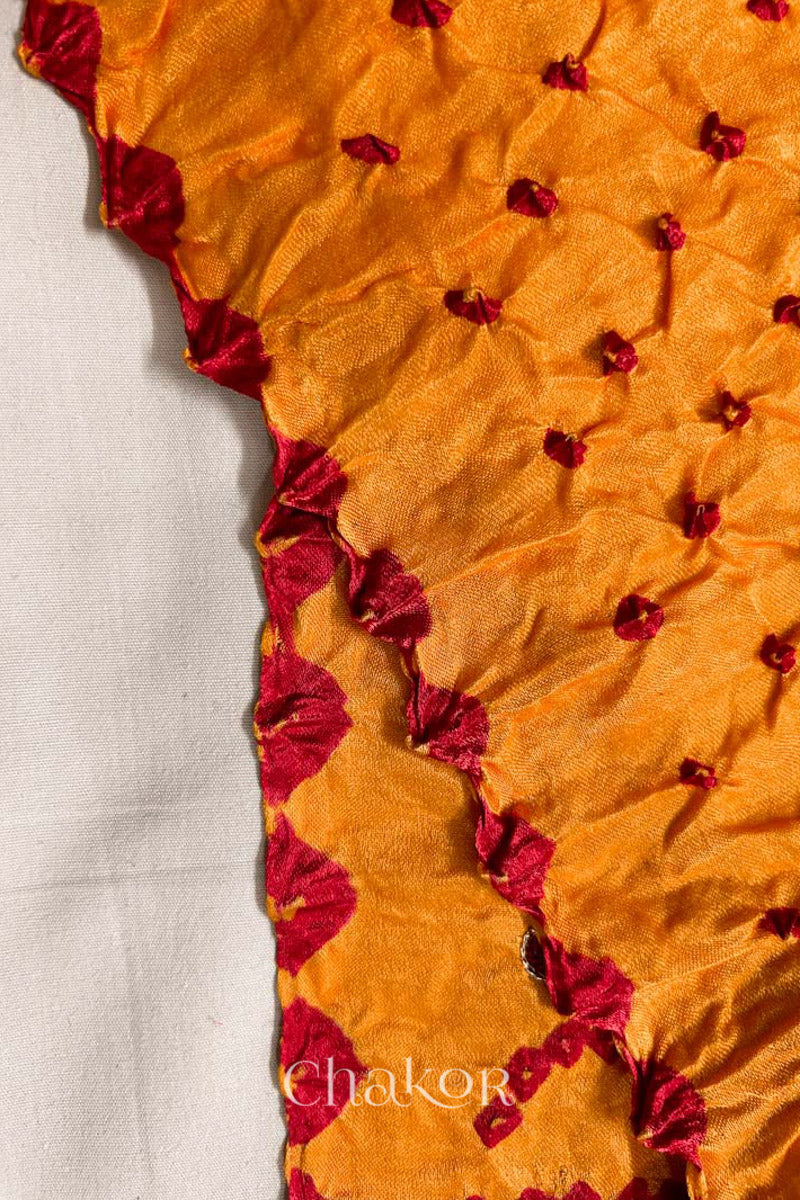 Close up of traditional Yellow Bandhani Gaji Silk Handcrafted Saree, with rai bandhej patterns in red dots.