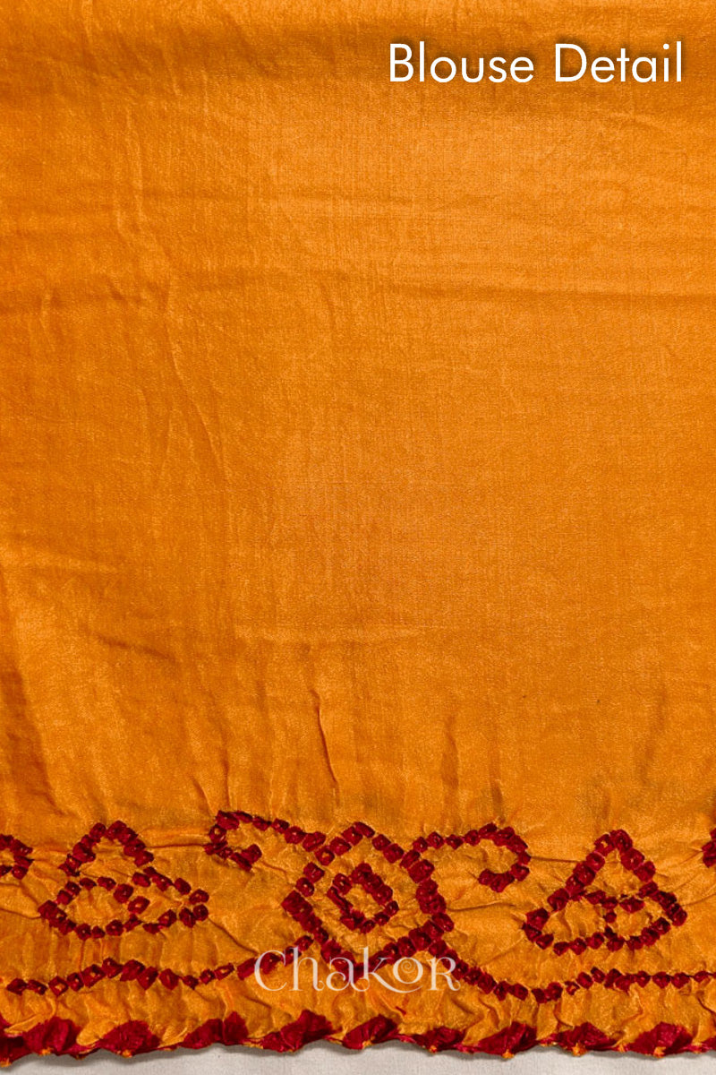 Blouse fabric detail of traditional Yellow Bandhani Gaji Silk Handcrafted Saree, with rai bandhej patterns in red dots.