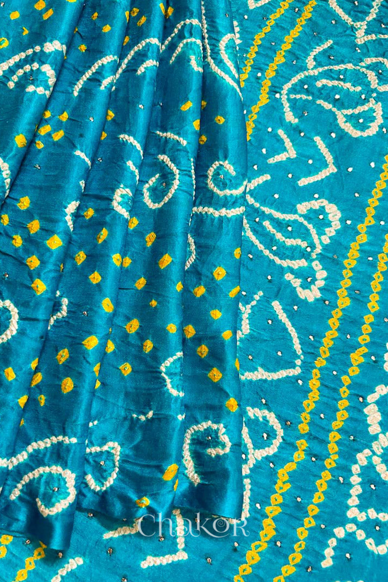Close up of Peacock Blue Bandhani Gaji Silk Saree, handcrafted with rai bandhej patterns and mukaish embroidery.