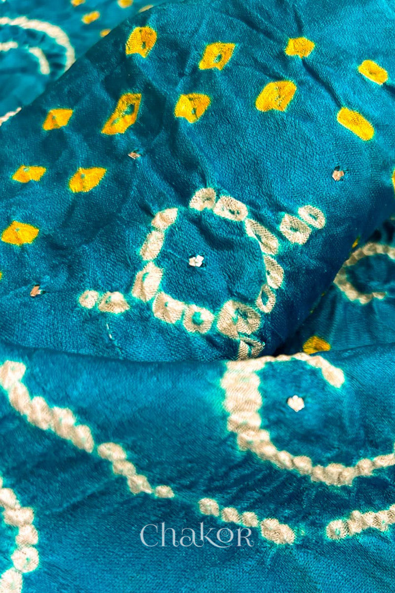 Close up of Peacock Blue Bandhani Gaji Silk Saree, handcrafted with rai bandhej patterns and mukaish embroidery.