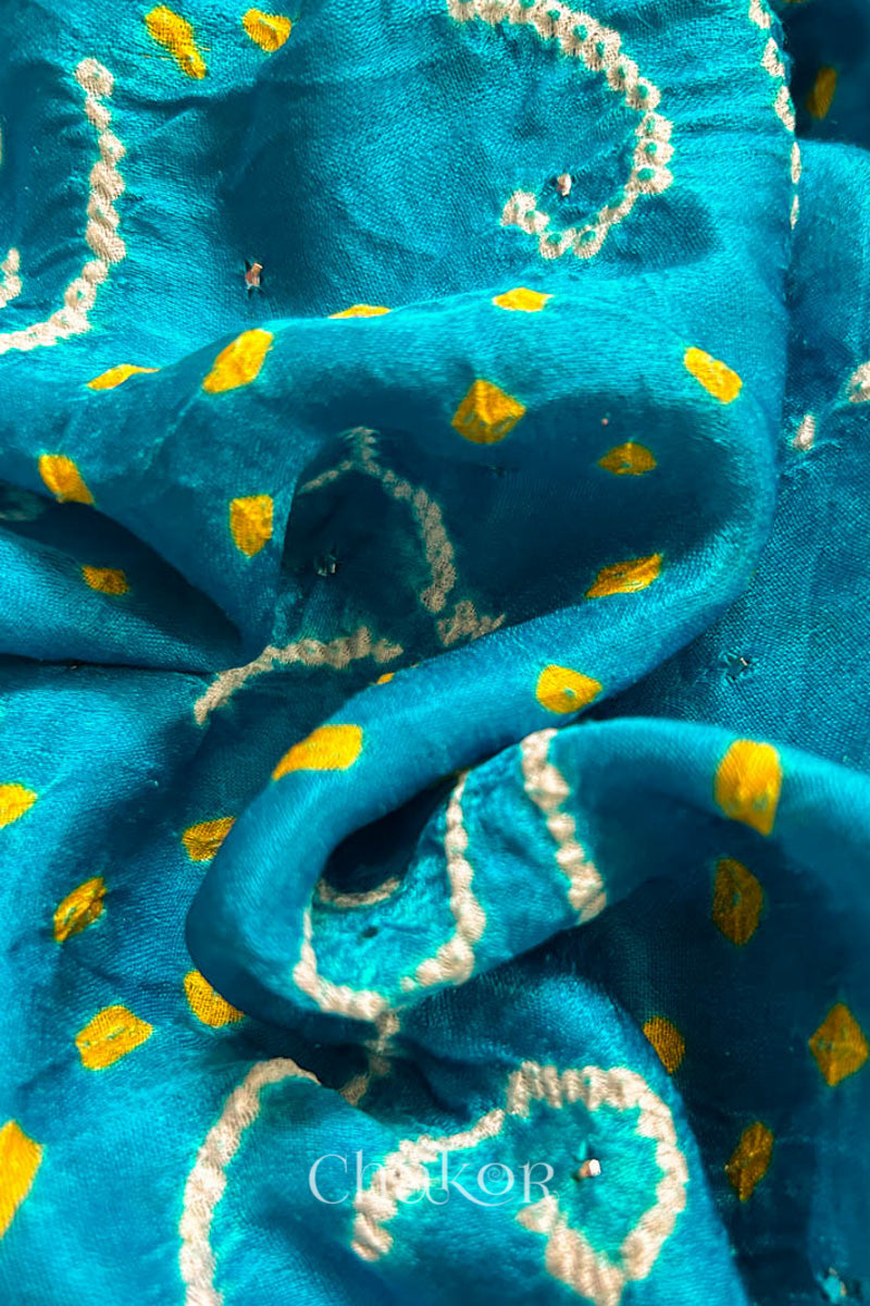 Close up of Peacock Blue Bandhani Gaji Silk Saree, handcrafted with rai bandhej patterns and mukaish embroidery.