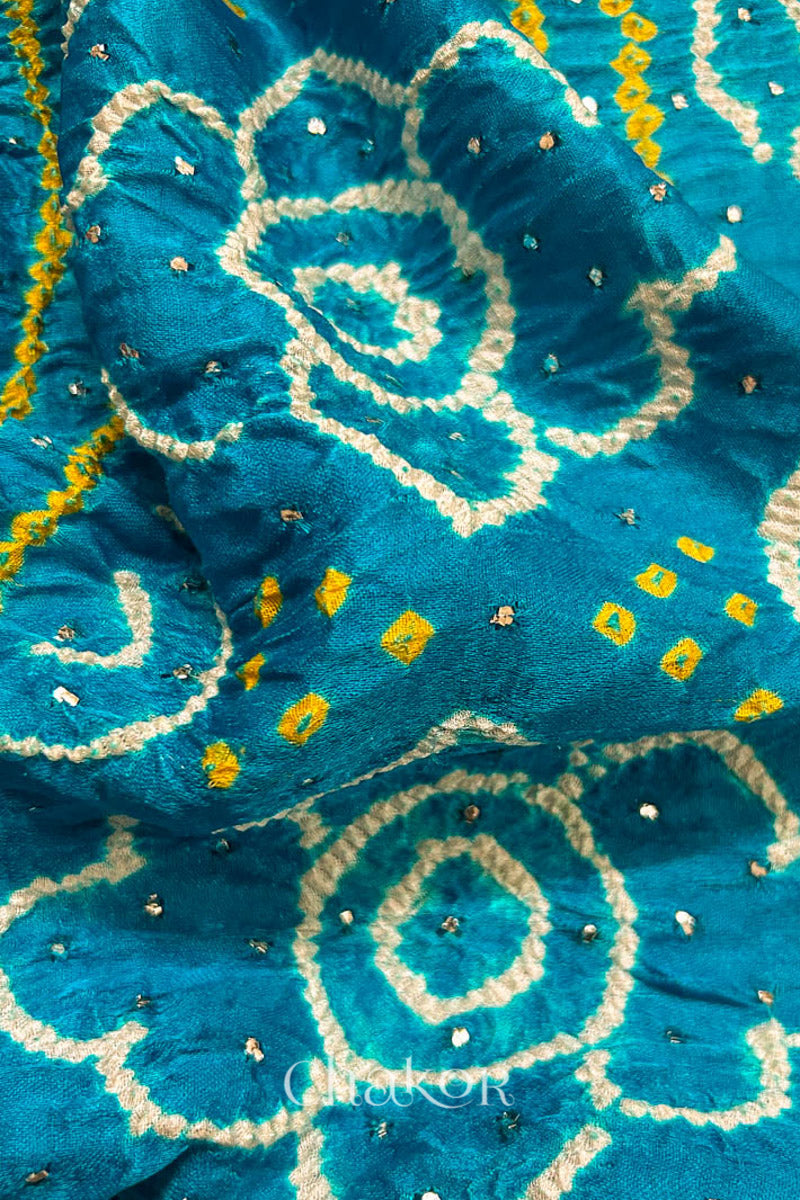 Close up of Peacock Blue Bandhani Gaji Silk Saree, handcrafted with rai bandhej patterns and mukaish embroidery.
