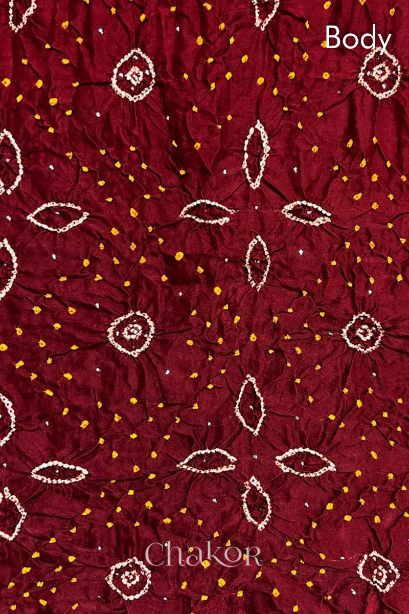 Body detail of Handcrafted Maroon Bandhani Gaji Silk Saree with traditional rai bandhej patterns and mukaish embroidery.