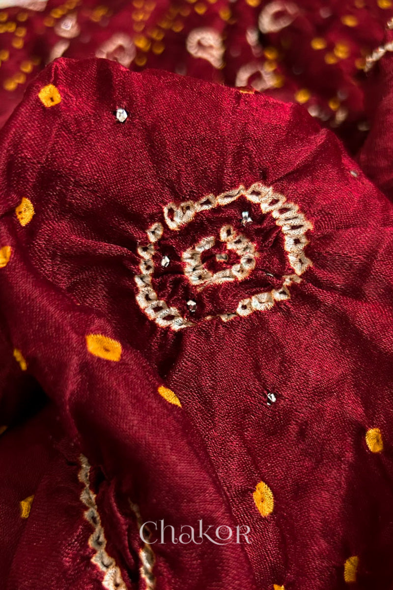 Close up of Handcrafted Maroon Bandhani Gaji Silk Saree with traditional rai bandhej patterns and mukaish embroidery.