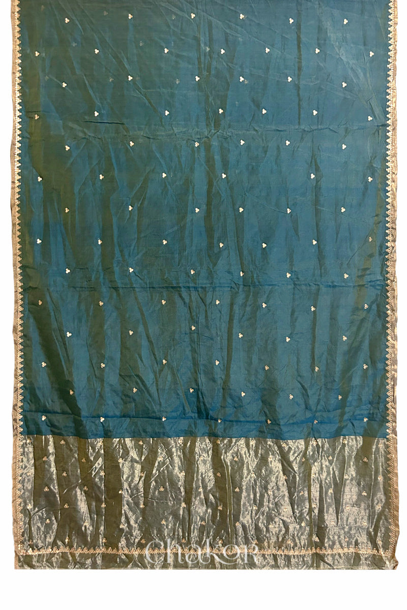 Full flatshot of Teal Blue Chanderi  silk cotton saree with embroidered motifs and zari border.
