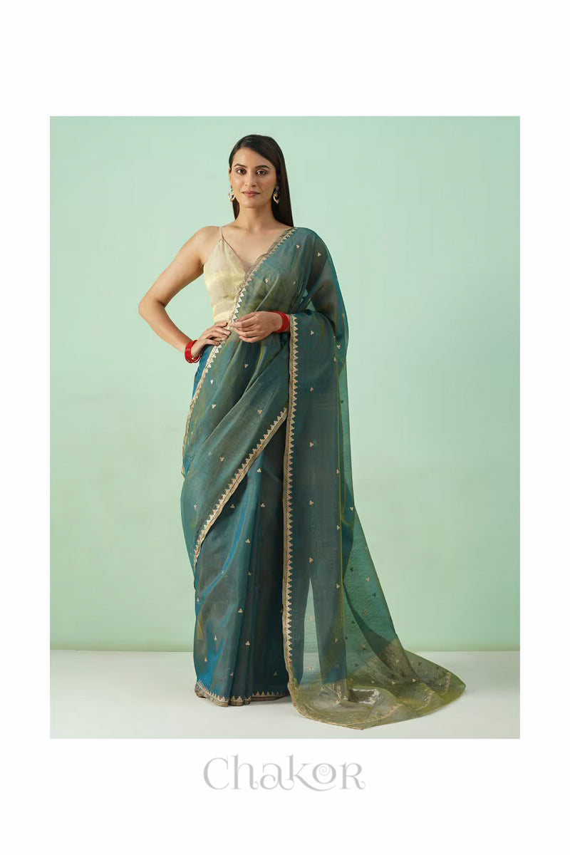 Model wearing Teal Blue Chanderi  silk cotton saree in a full-length promotional shot.
