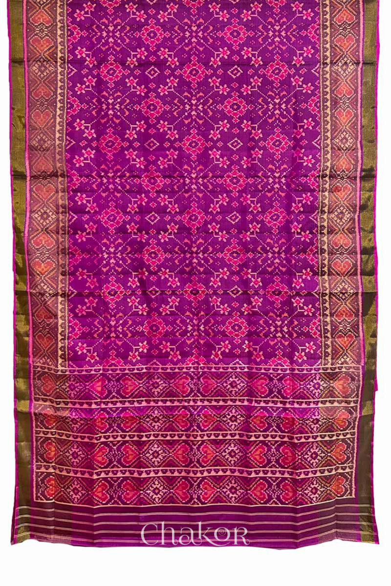 Full view of Handloom Magenta Pink Rajkoti Patola Ikat Mulberry Silk Saree with tissue borders, woven using traditional designs in Gujarat.