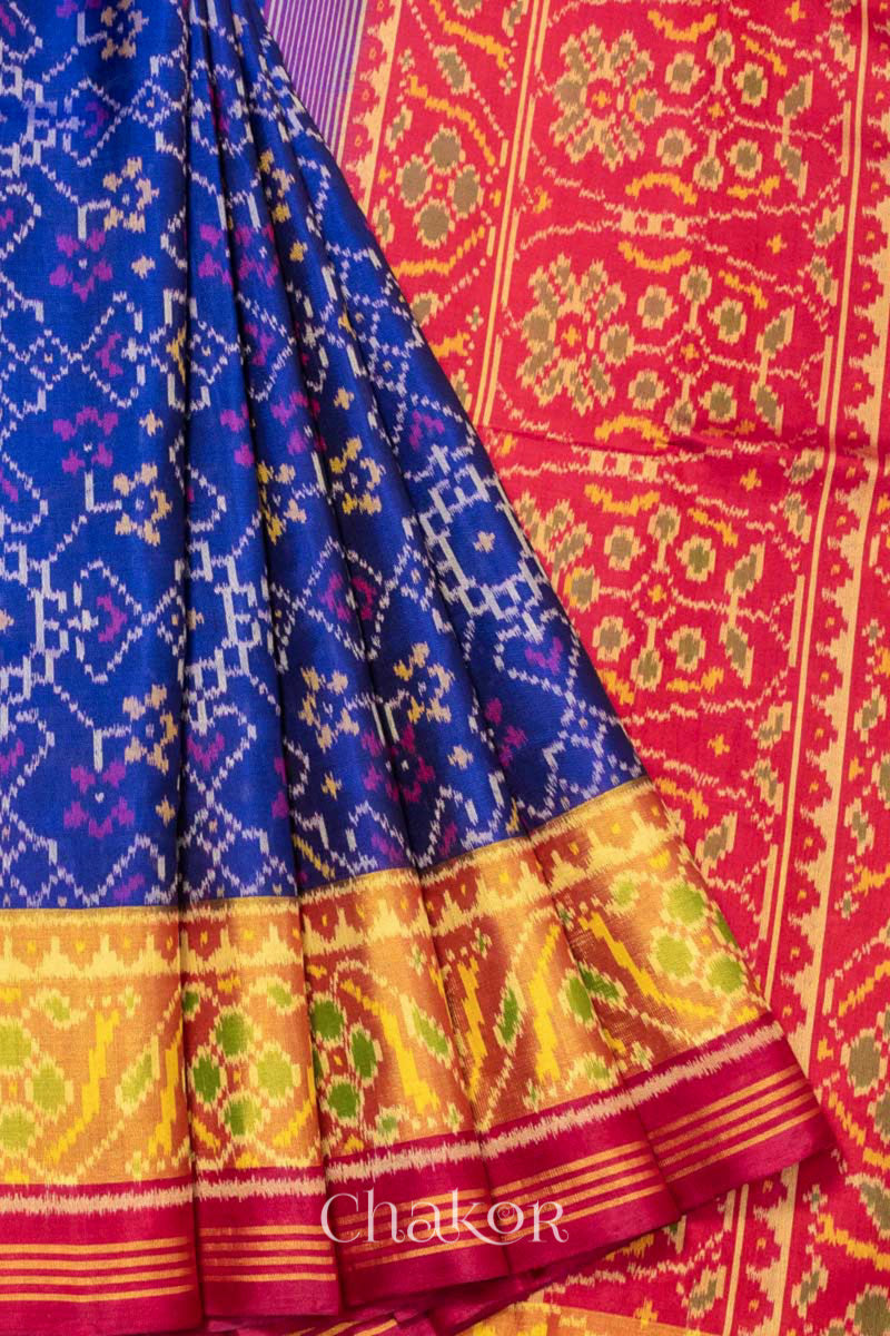 Close up of Handloom Blue and Red Ikat Patola Mulberry Pure Silk Saree, with traditional design handcrafted in Rajkot.