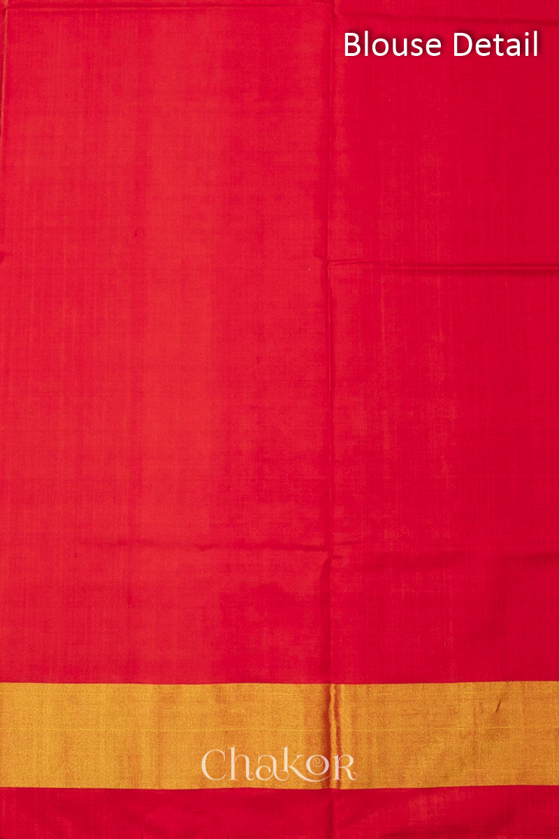 Blouse material detail of Handloom Rust Rajkoti Patola Ikat Mulberry Silk Saree with Red borders & pallu, woven using traditional designs in Gujarat.