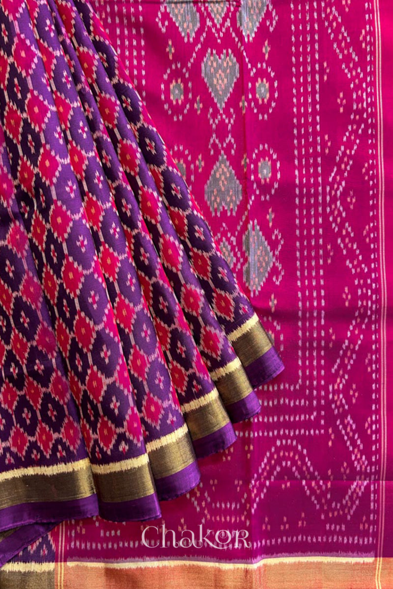 Pleats laid flat on pallu Handloom Purple Pink Patola Ikkat Mulberry Silk Saree in traditional patterns.
