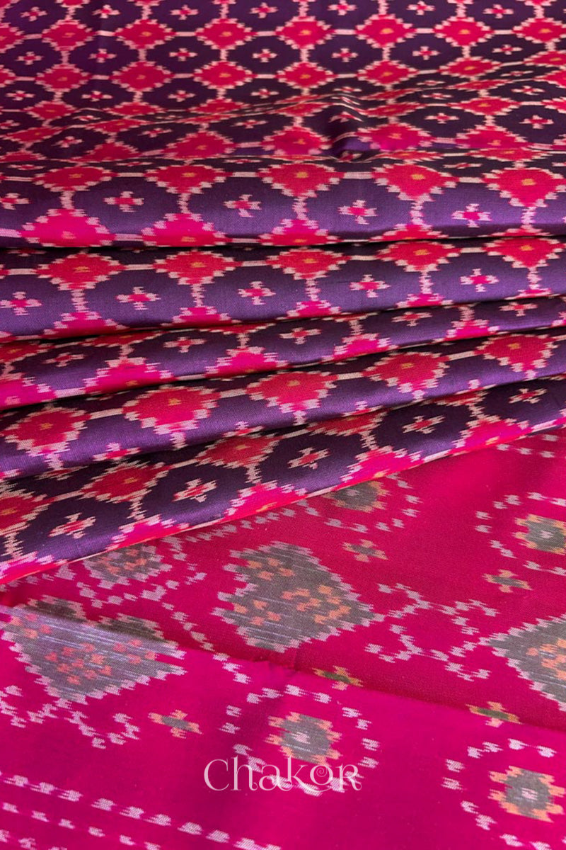 Pleats laid flat on pallu Handloom Purple Pink Patola Ikkat Mulberry Silk Saree in traditional patterns.