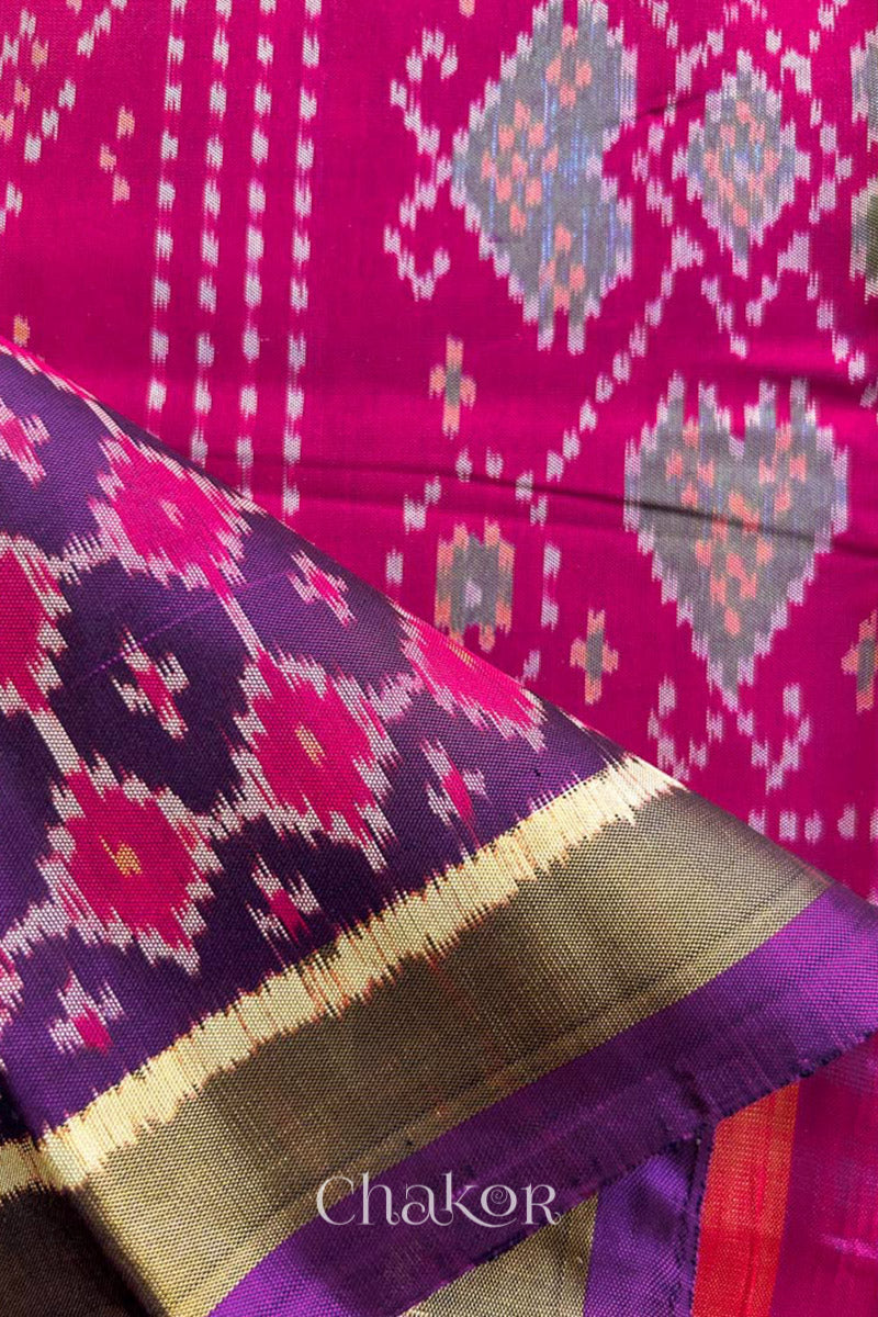 Close up of Handloom Purple Pink Patola Ikkat Mulberry Silk Saree in traditional patterns.