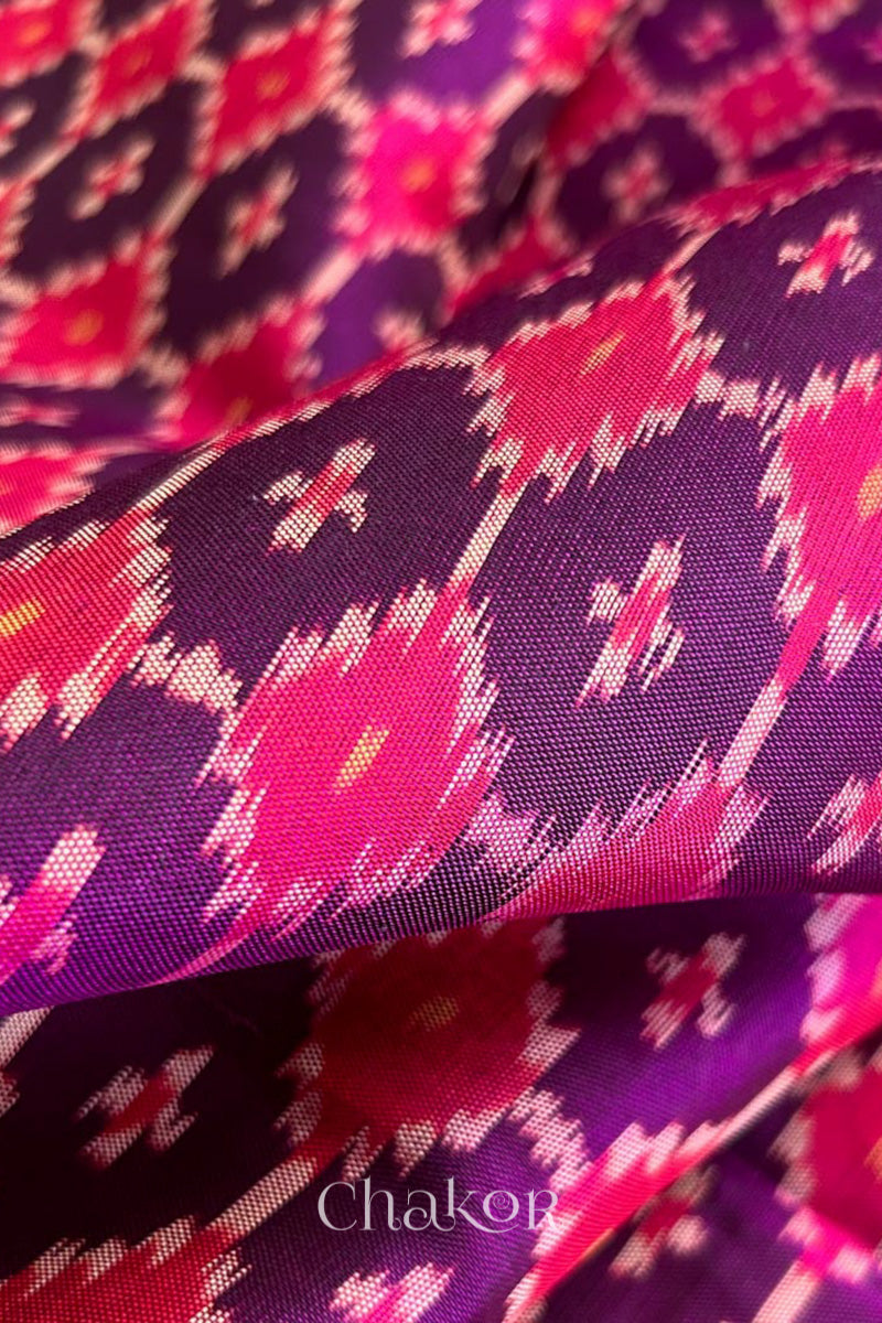 Close up of Handloom Purple Pink Patola Ikkat Mulberry Silk Saree in traditional patterns.