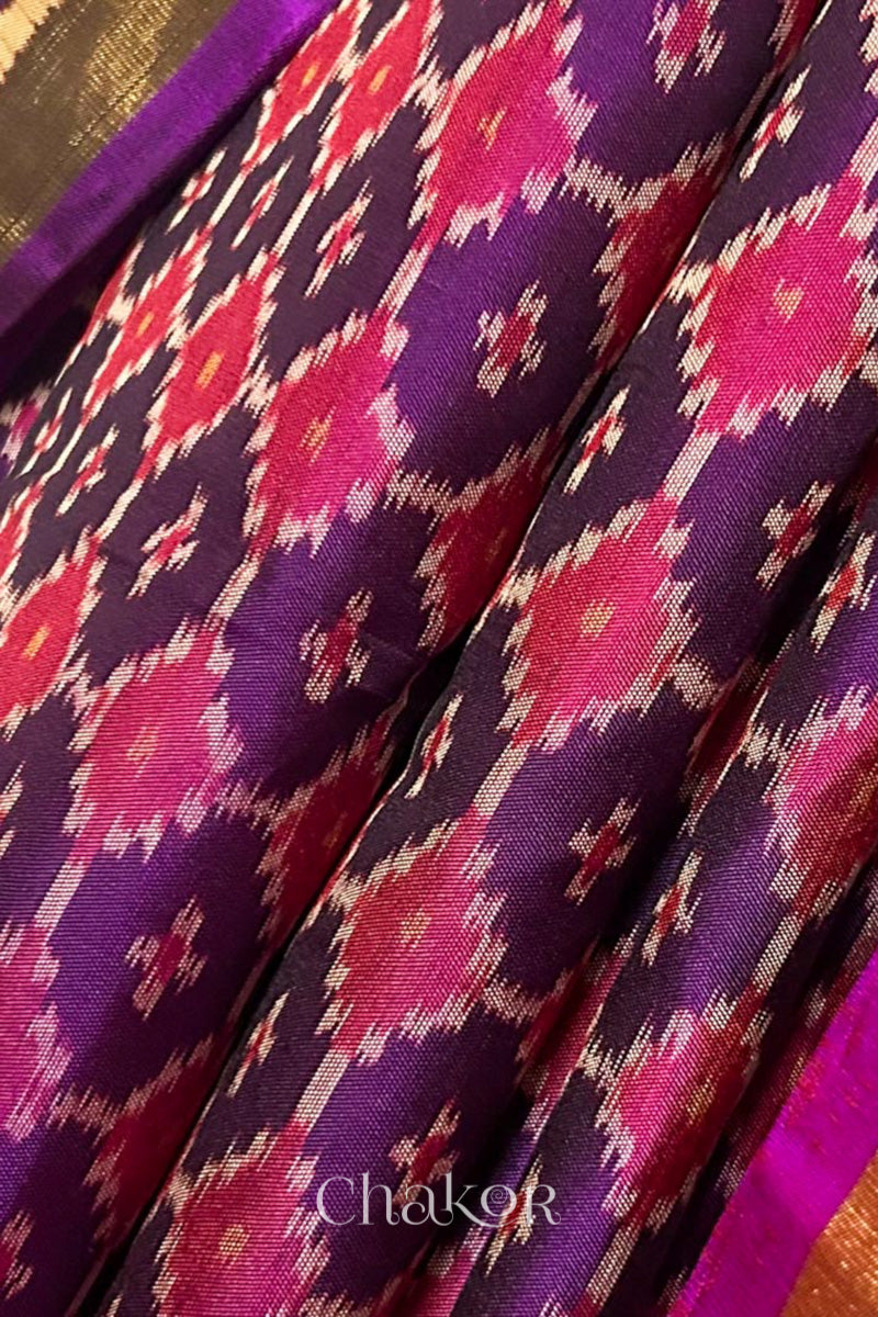 Close up of Handloom Purple Pink Patola Ikkat Mulberry Silk Saree in traditional patterns.