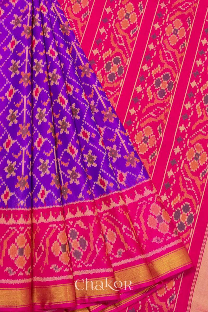 Pleats and pallu view of Handloom Purple Pink Ikat Patola Mulberry Silk Saree with traditional design.