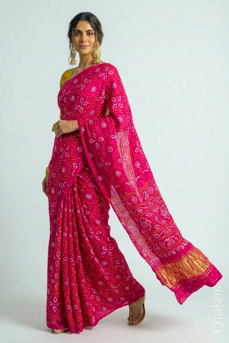 Woman wearing Handcrafted Rani pink Bandhani Gaji Silk Saree with traditional bandhej patterns and sequins embroidery.