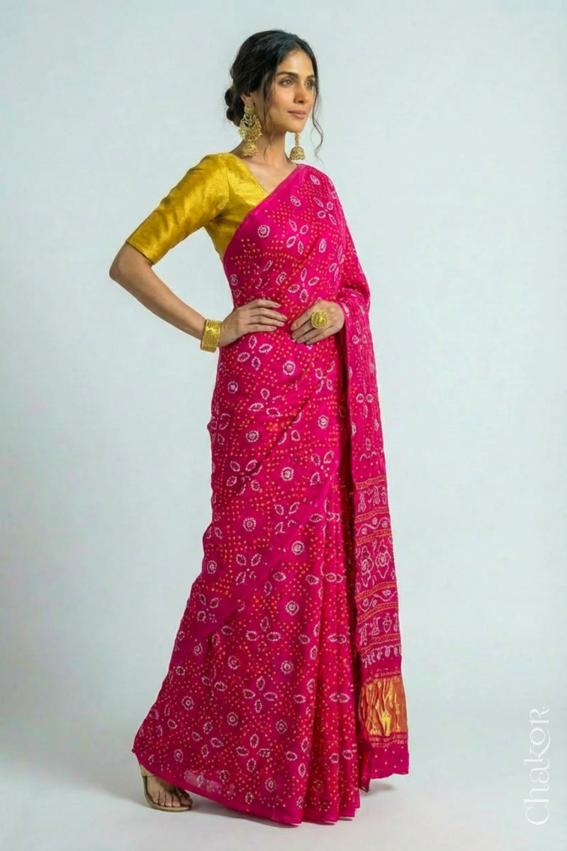 Woman wearing Handcrafted Rani pink Bandhani Gaji Silk Saree with traditional bandhej patterns and sequins embroidery.