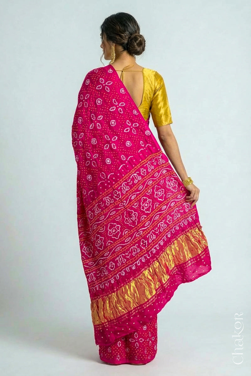 Woman wearing Handcrafted Rani pink Bandhani Gaji Silk Saree with traditional bandhej patterns and sequins embroidery.