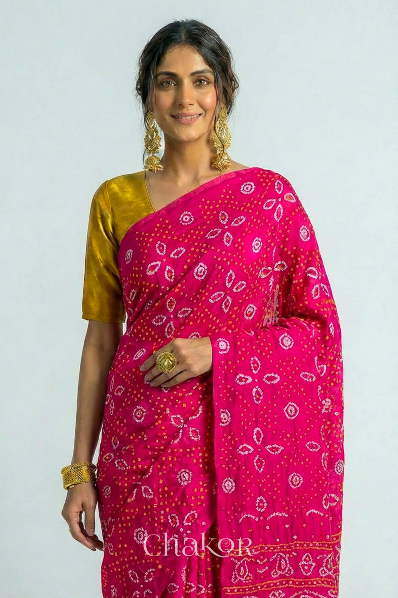 Woman wearing Handcrafted Rani pink Bandhani Gaji Silk Saree with traditional bandhej patterns and sequins embroidery.