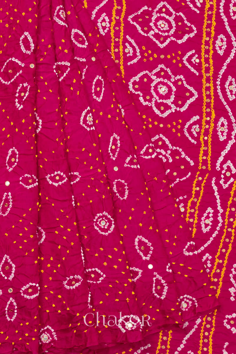 Close up of Handcrafted Rani pink Bandhani Gaji Silk Saree with traditional bandhej patterns and sequins embroidery.