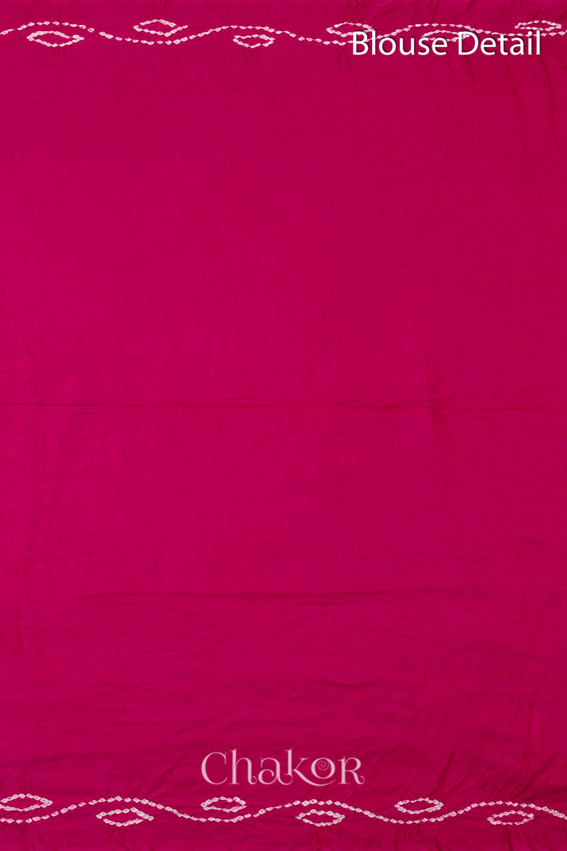 Close up of Handcrafted Rani pink Bandhani Gaji Silk Saree with traditional bandhej patterns and sequins embroidery.