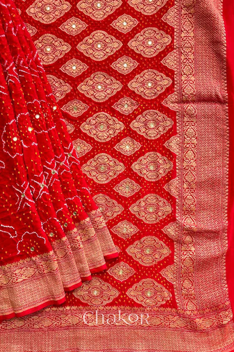 Close up of  Handcrafted Red Bandhani Banarasi Georgette Saree in pure silk featuring zari weaving and Kutch Bandhej with mirror embroidery, Perfect for wedding and occasions.