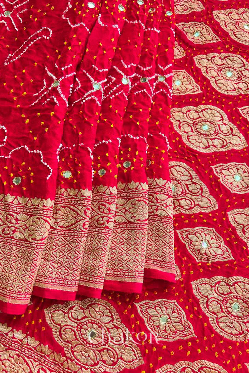 Close up of  Handcrafted Red Bandhani Banarasi Georgette Saree in pure silk featuring zari weaving and Kutch Bandhej with mirror embroidery, Perfect for wedding and occasions.