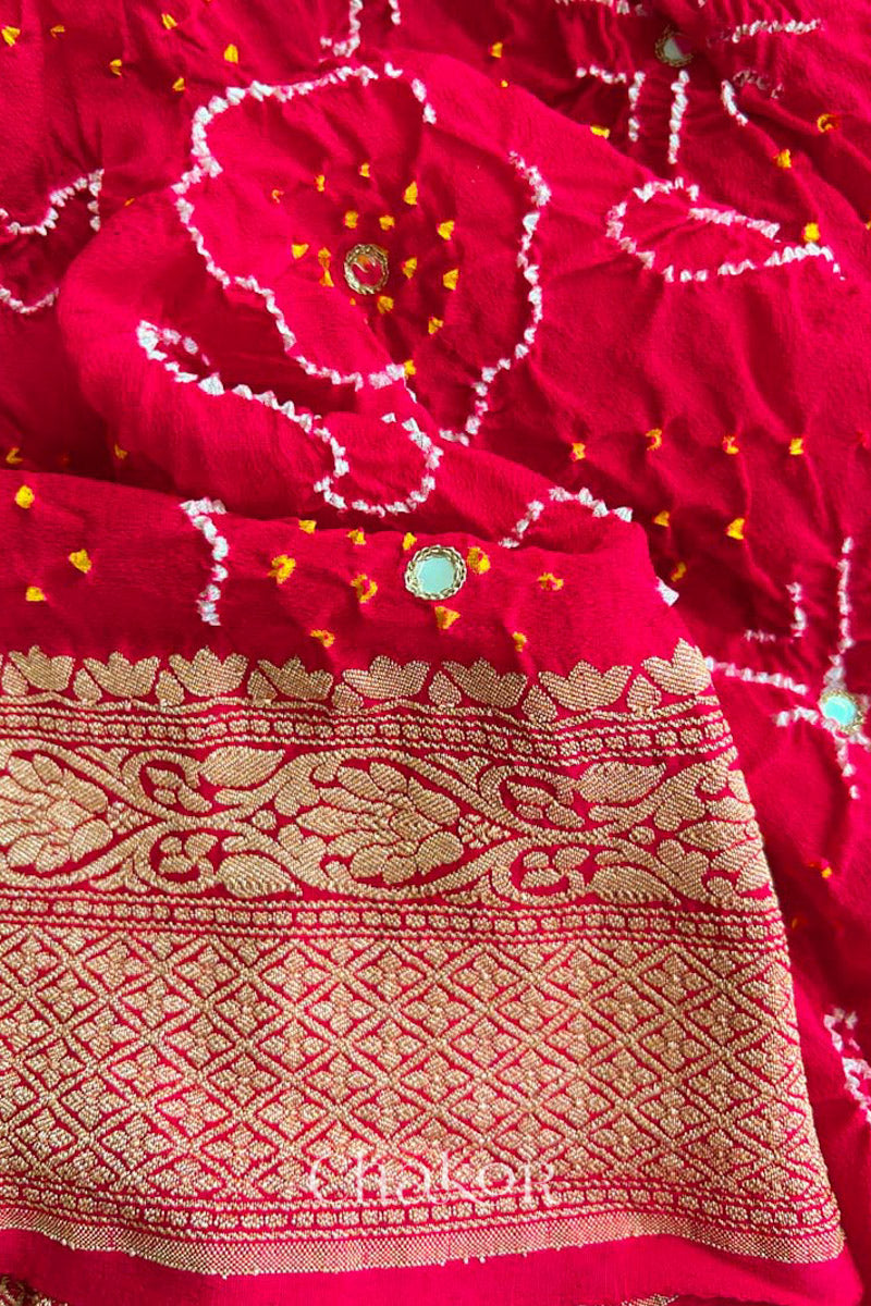 Close up of  Handcrafted Red Bandhani Banarasi Georgette Saree in pure silk featuring zari weaving and Kutch Bandhej with mirror embroidery, Perfect for wedding and occasions.