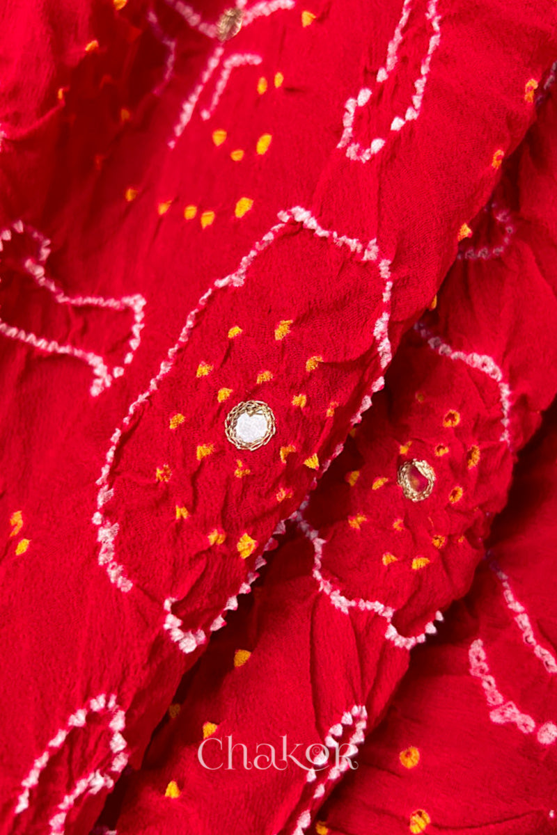 Close up of  Handcrafted Red Bandhani Banarasi Georgette Saree in pure silk featuring zari weaving and Kutch Bandhej with mirror embroidery, Perfect for wedding and occasions.